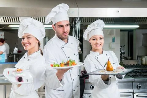 Chef Cooking, Cutting and preparing next plate Stock Photos