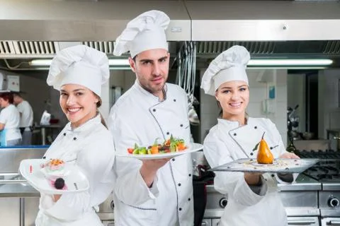 Chef Cooking, Cutting and preparing next plate Stock Photos
