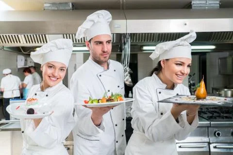 Chef Cooking, Cutting and preparing next plate Stock Photos