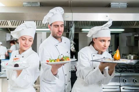 Chef Cooking, Cutting and preparing next plate Stock Photos
