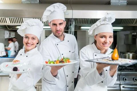 Chef Cooking, Cutting and preparing next plate Stock Photos