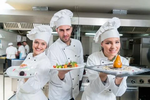 Chef Cooking, Cutting and preparing next plate Stock Photos