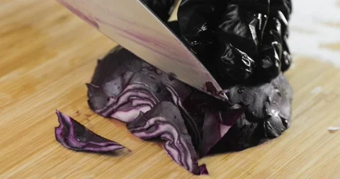 Chef is cooking cutting fresh red cabbage on wooden board, hands closeup. Vídeo Stock 147347420