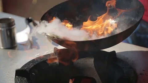 Chef Cooking With Fire In Frying Pan on a Street food Festival Stock Footage
