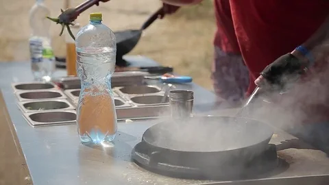 Chef Cooking With Fire In Frying Pan on a Street food Festival Stock Footage 79467374