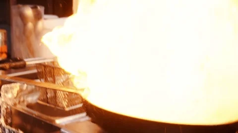 Chef Cooking With Fire In Frying Pan. Professional Chef In A Commercial Kitchen Video stock 118762146