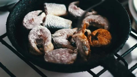 Chef is cooking fish in a frying pan until golden brown Vídeos de archivo 74257669