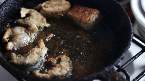 Chef is cooking fish in a frying pan until golden brown Stock Footage