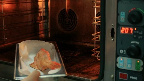 The chef is cooking fish in the restaurant. puts in an iron tray in the oven Stock Footage 92939654