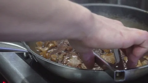 Chef cooking with flame in a frying pan on a kitchen stove Stock Footage 71961463