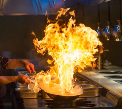 Chef cooking with flame Stock Photos