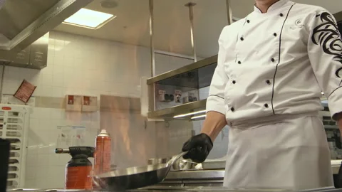Chef Cooking with Flaming Pan Stock Footage 318345561