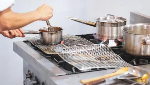 Chef cooking food in the kitchen, Chef preparing food Stock Photos
