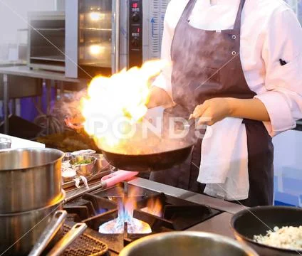 Chef cooking food in the kitchen, Chef preparing food Stock Photos