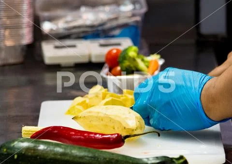 Chef cooking food, vegetables in the kitchen Stock Photos
