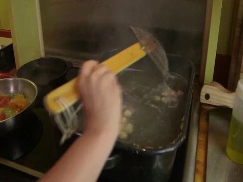 Chef cooking gnocci in a broth Stock Footage 71556132
