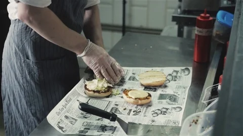 Chef cooking hamburger beef and chicken burgers on restaurant kitchen, man in Stock Footage 75239655