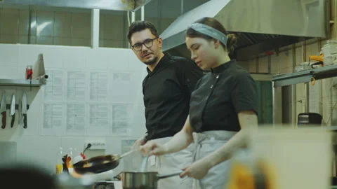 Chef Cooking with Help of Female Apprentice in Restaurant Kitchen Video stock 270153237