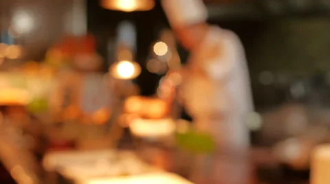 Chef cooking  in kitchen with blurry image Stock Footage 66111922