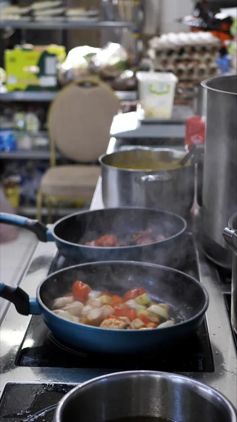 Chef cooking in the kitchen. vegetables and meat on a frying pan Stock Footage 306321005