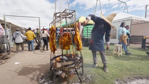 Chef cooking llanera style meat outdoors at a traditional ecuadorian fair Video stock 335700738