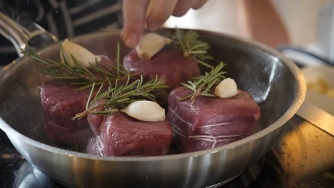 Chef cooking meat in pan Stock Footage 102917963