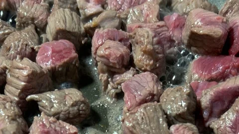 Chef cooking meat, raw beef slice on sunflower oil in frying pan on kitchen Stock Footage 303780151