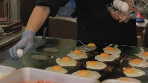 Chef Cooking Multiple Eggs At Once On A Large Flat-top Griddle In Tokyo, Japan Stock Footage 342187262