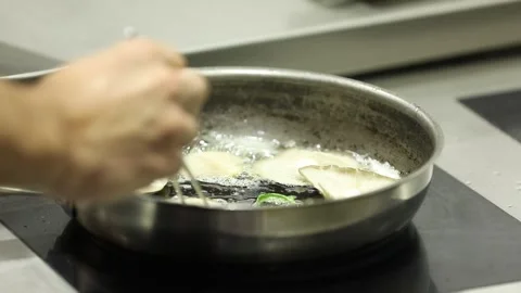 The chef is cooking mushrooms 4 Stock Footage 314977764
