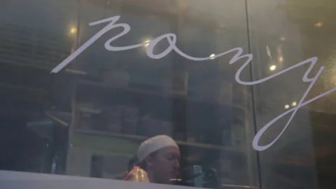 Chef Cooking with Open Flames Behind Glass Window in Sydney Restaurant Kitchen Stock Footage 345743336
