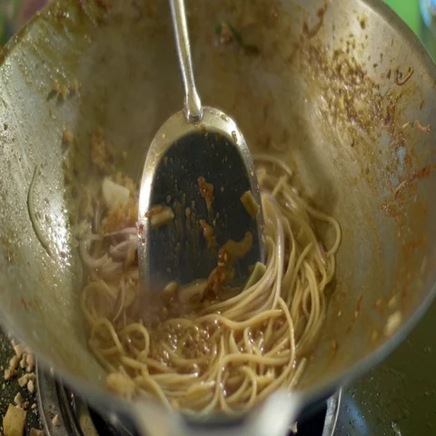 Chef cooking Pad Thai stir-fried rice noodles with shrimp in pan Stock Footage