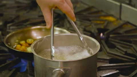 Chef cooking pasta in pot, boiling water Stock Footage 157282881