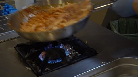 Chef is cooking pasta. Process of cooking pasta in tomato sauce with greens. Stock Footage 92346259