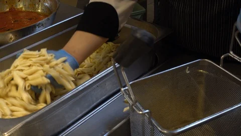 Chef is cooking pasta. Process of cooking pasta in tomato sauce with greens. Stock Footage 111561816