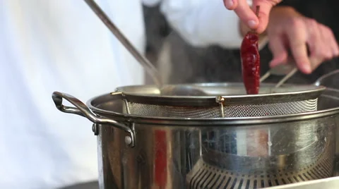 Chef cooking pepper in crock Stock Footage 64801707