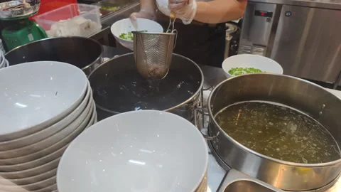 Chef Cooking Pho uses fresh ingredients for broth. Skilled Chef Cooking Pho Stock Footage 325490854