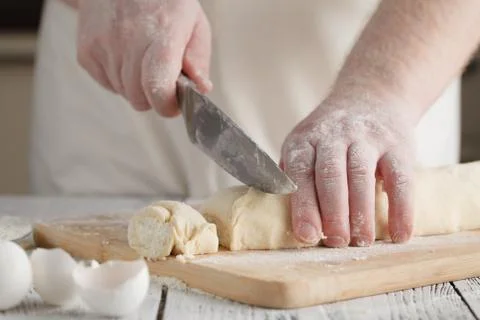 Chef cooking (preparing cottage cheese pancakes) on a wooden board Stock Photos