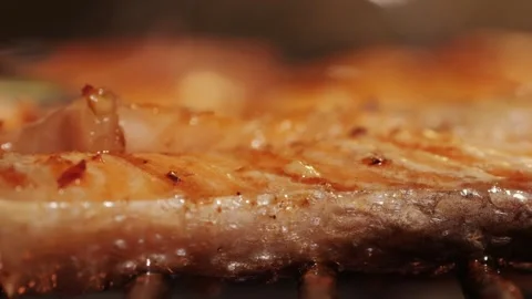 Chef cooking red salmon fish steaks with oil and spices on grill close-up Stock Footage 270019880