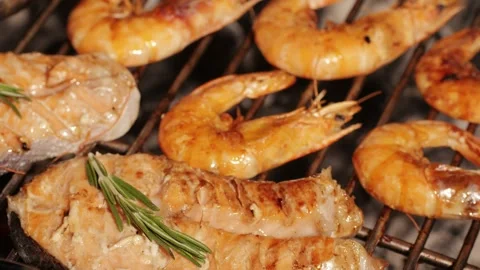 Chef cooking red salmon fish steaks with oil and spices on grill close-up Stock Footage 274320098