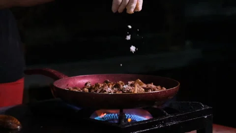 Chef cooking in a restaurant, adding ingredients Stock Footage 247995790