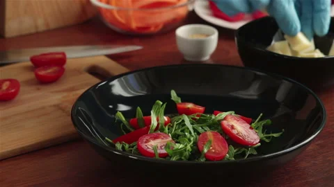 Chef cooking salad with arugula cherry tomato diced cheese carrot slice Stock Footage 116551048