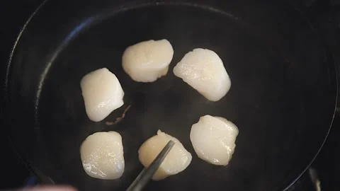 The chef is cooking scallops Stock Footage 130988891