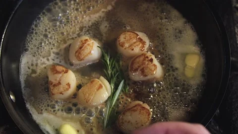 The chef is cooking scallops Stock Footage 130989050