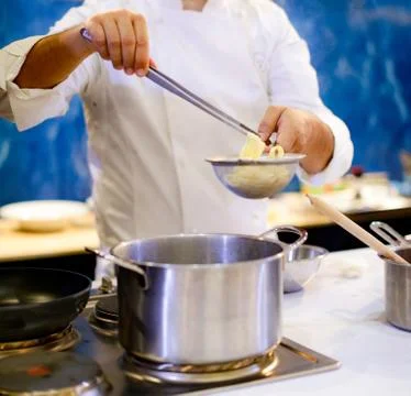 Chef cooking spaghetti in the kitchen Stock Photos