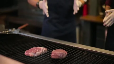 Chef cooking steaks on the grill Stock Footage 67862588