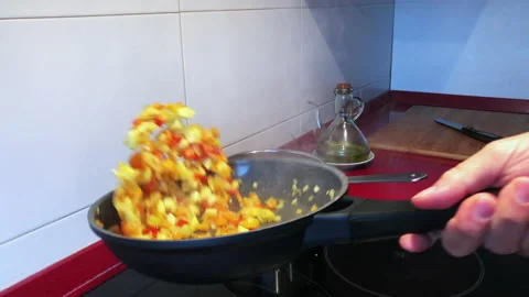 Chef cooking vegetable in frying pan on burning fire slow motion Stock Footage 144454275