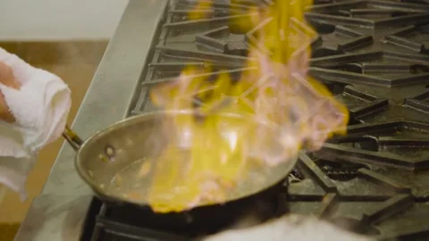 Chef cooking vegetables, fire in pan Stock Footage 157282869