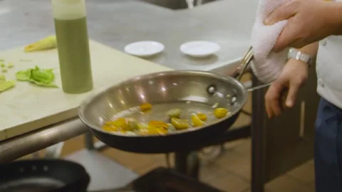 Chef cooking vegetables, flipping pan Stock Footage 157282858