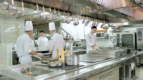 Chef cooking vegetables in pan in the kitchen of the restaurant or hotel Video stock 106186694