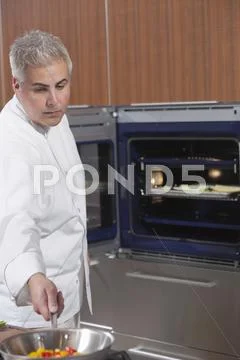 Chef Cooking Vegetables In Work Pan Stock Photos